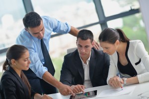 Group of happy young  business people in a meeting at office