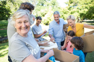 Happy volunteer family separating donations stuffs on a sunny da