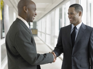 Happy African American businessmen shaking hands while standing